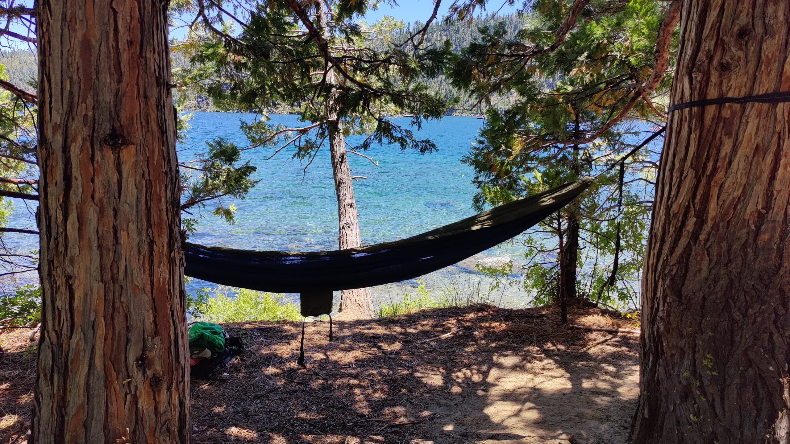 Gear laid out on a wooden camp table at dawn.