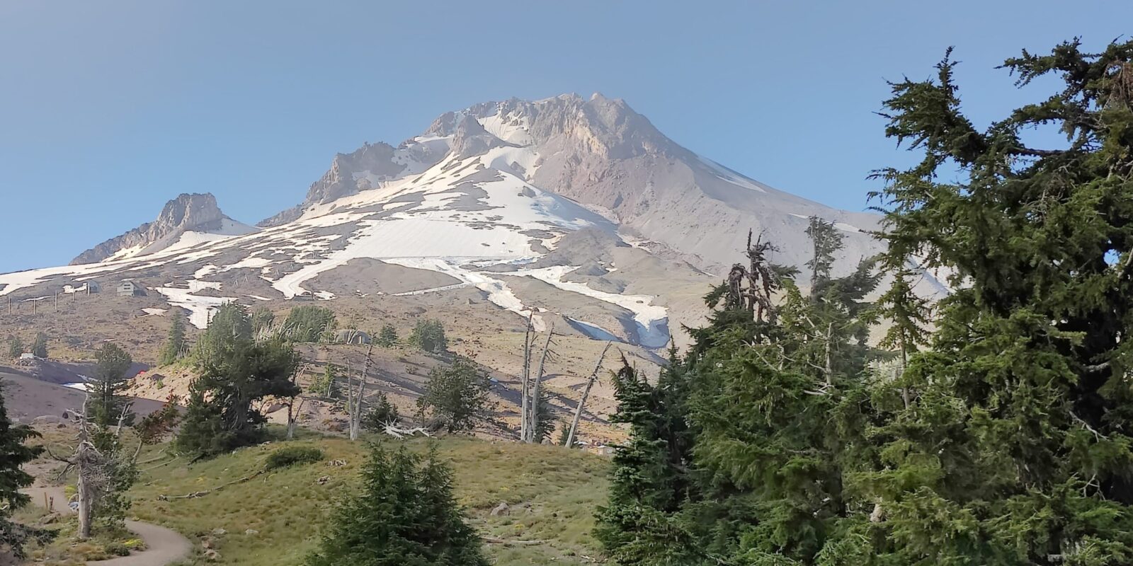 A forested Pacific Northwest ridgeline at dusk.